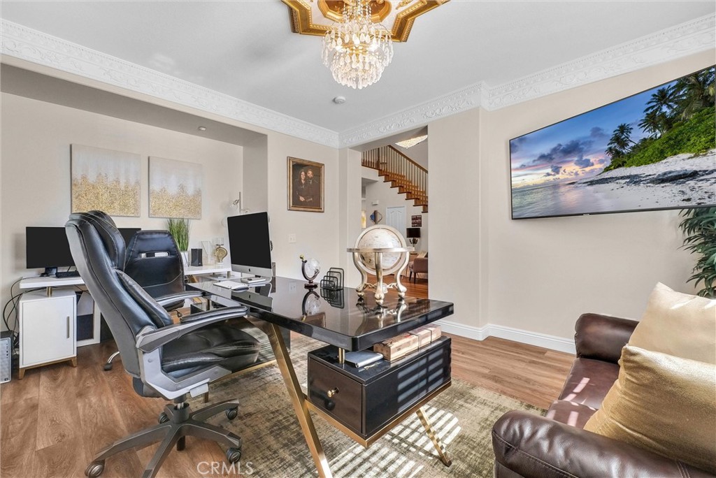 11499 Bridgeway Drive Riverside, CA 92505 - Photo 18 of 65 a living room with furniture and a laptop computer sitting on wooden floor