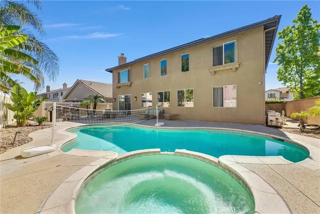 a living room with furniture flat screen tv and windows