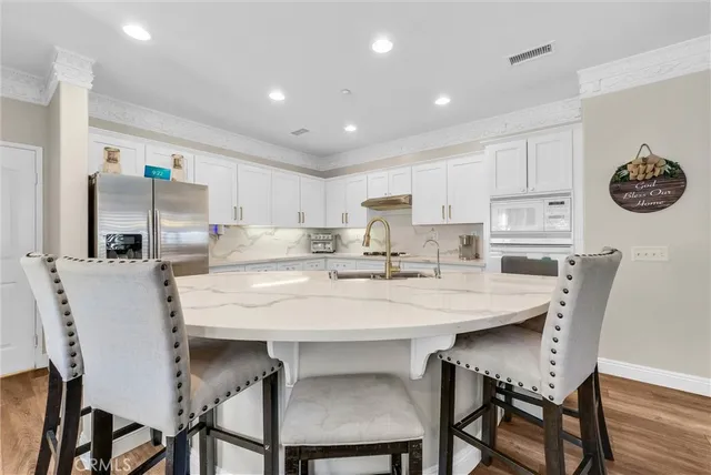 a living room with furniture and painting on the wall