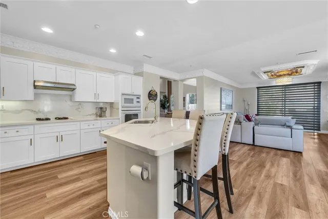 a spacious bedroom with a bed and a chandelier