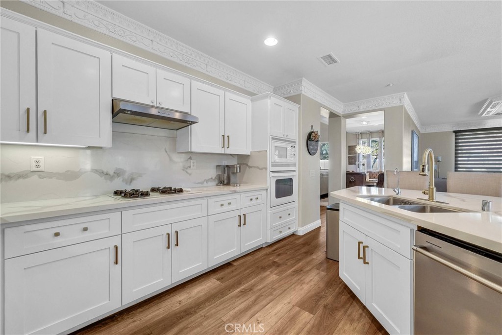 11499 Bridgeway Drive Riverside, CA 92505 - Photo 23 of 65 a kitchen with granite countertop white cabinets and white appliances