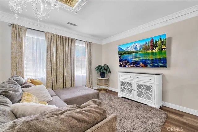 a spacious bedroom with a bed and a chandelier