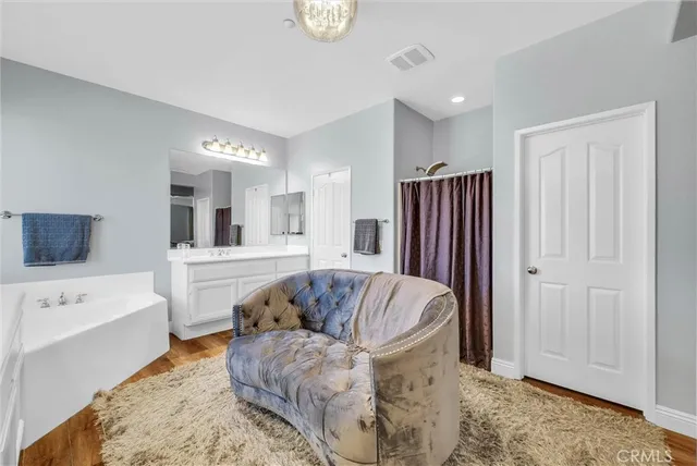 a bathroom with a sink double vanity granite and a toilet