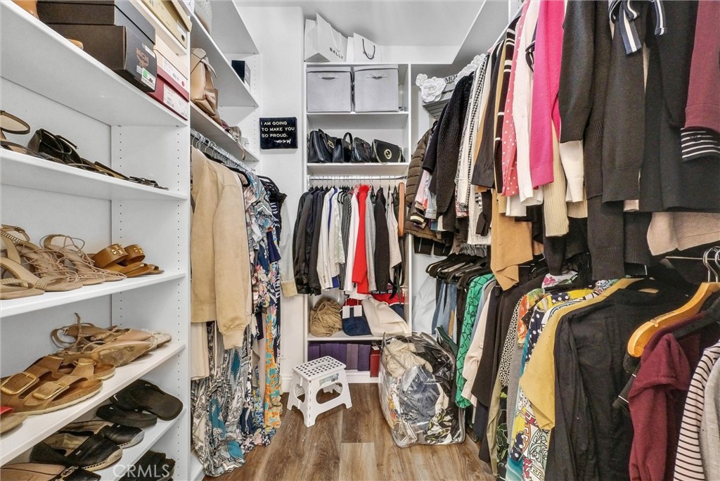 11499 Bridgeway Drive Riverside, CA 92505 - Photo 32 of 65 a view of walk in closet with clothes and shoes