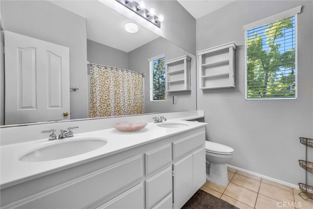 11499 Bridgeway Drive Riverside, CA 92505 - Photo 37 of 65 a bathroom with a sink double vanity granite and a toilet