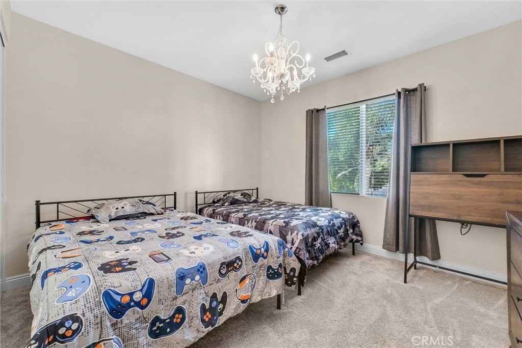 11499 Bridgeway Drive Riverside, CA 92505 - Photo 39 of 65 a bedroom with a bed and a table in it