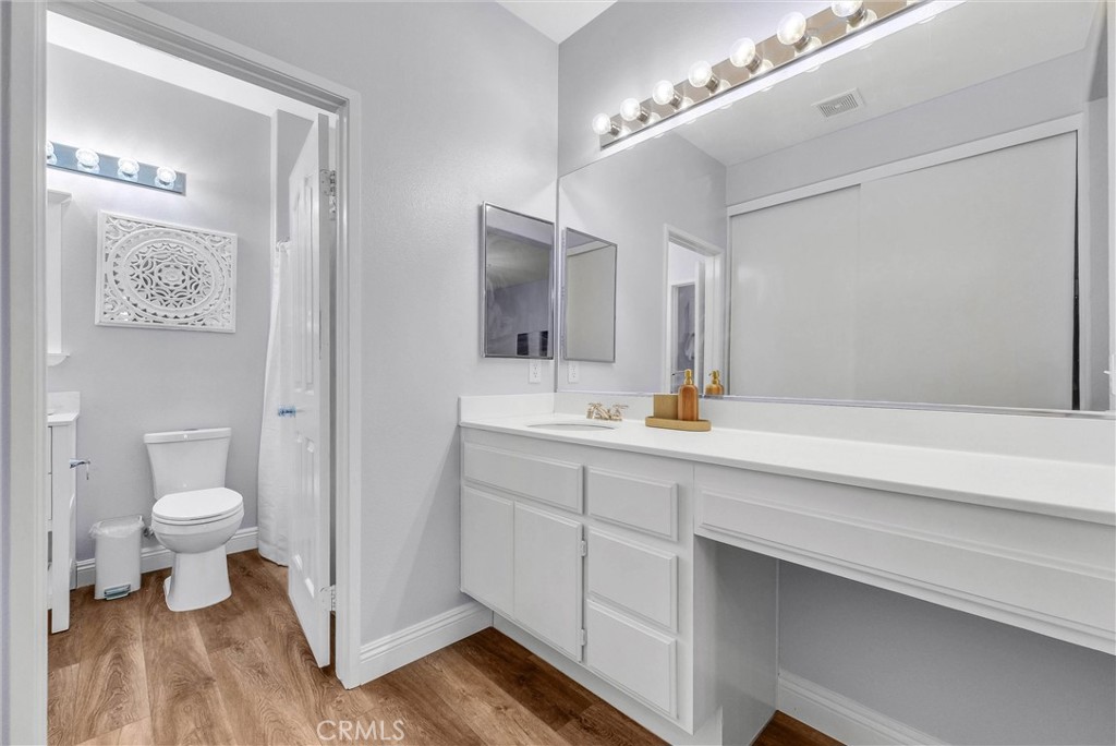 11499 Bridgeway Drive Riverside, CA 92505 - Photo 43 of 65 a bathroom with a sink a toilet and a mirror