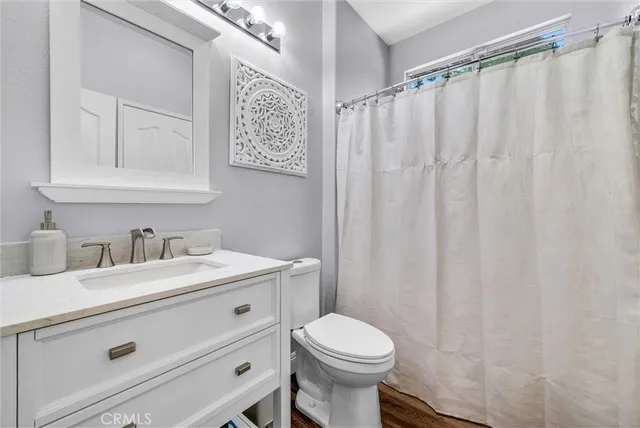 a view of a backyard with couches plants and wooden fence