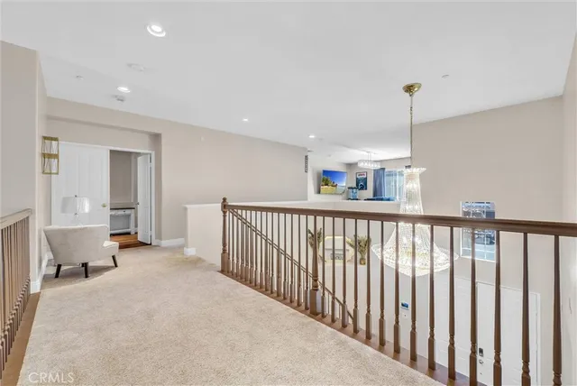 a living room with furniture a chandelier and a fireplace