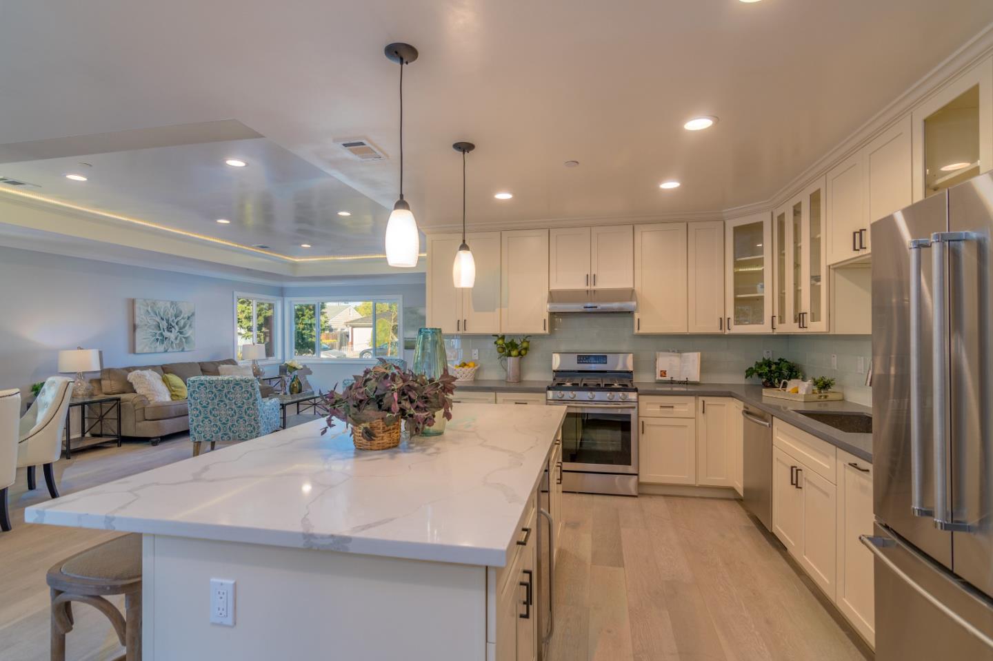 654 Malarin Avenue Santa Clara, CA 95050 - Photo 11 of 31 a kitchen with stainless steel appliances granite countertop a sink refrigerator and cabinets