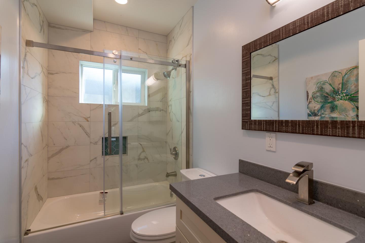 654 Malarin Avenue Santa Clara, CA 95050 - Photo 15 of 31 a bathroom with a granite countertop sink toilet and shower