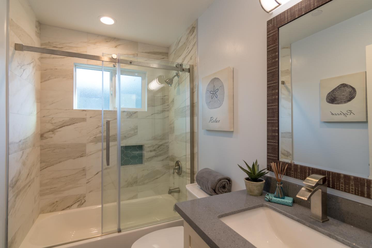 654 Malarin Avenue Santa Clara, CA 95050 - Photo 19 of 31 a bathroom with a tub shower sink and mirror