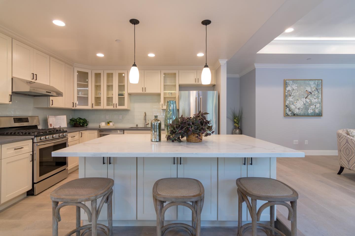 654 Malarin Avenue Santa Clara, CA 95050 - Photo 10 of 31 a kitchen with stainless steel appliances granite countertop a sink a stove a refrigerator and chairs