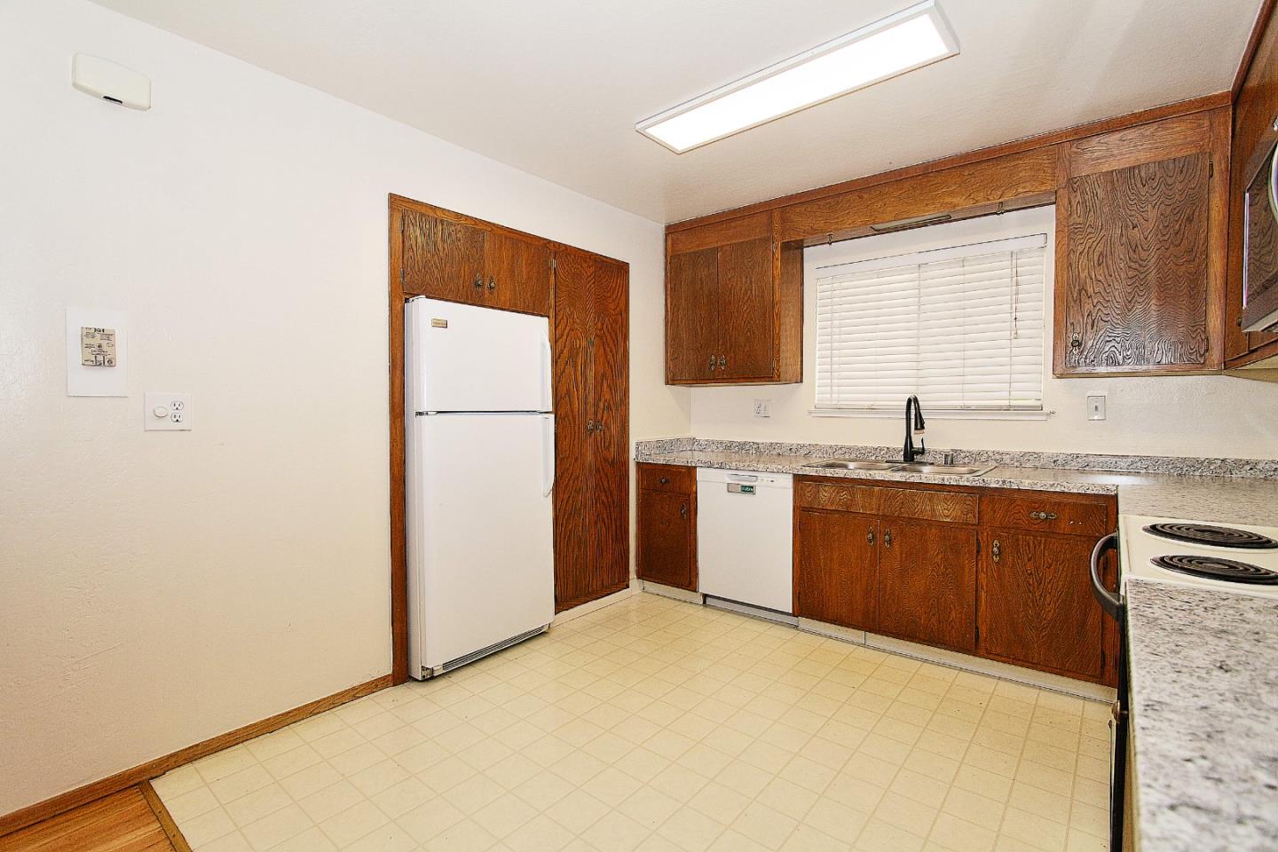 3310 Invicta Way San Jose, CA 95118 - Photo 7 of 23 a kitchen with granite countertop a refrigerator a sink and white cabinets