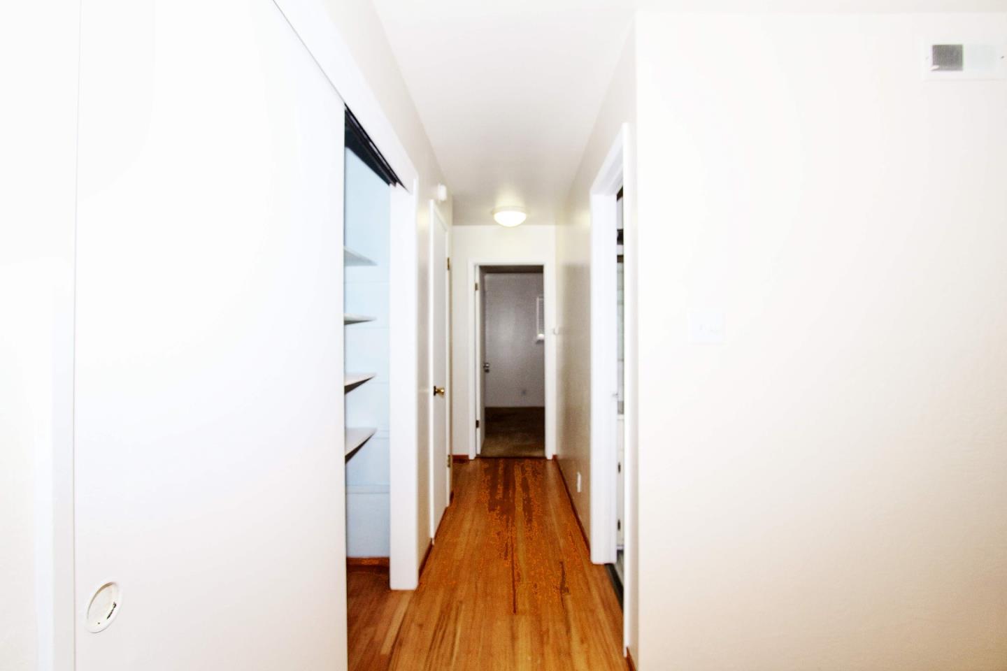 3310 Invicta Way San Jose, CA 95118 - Photo 9 of 23 a view of a hallway with wooden floor and a bathroom