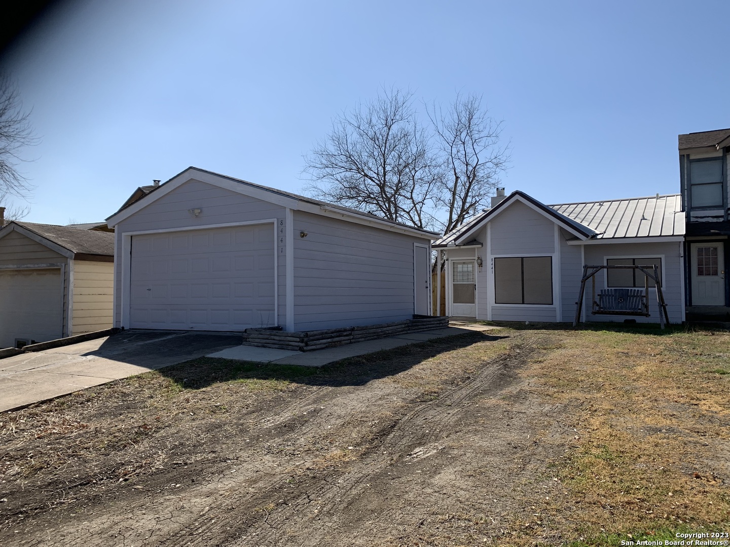 8441 Forest Ridge Drive, Unit 80 San Antonio, TX 78239 - Photo 1 of 1 a front view of a house with a yard and garage