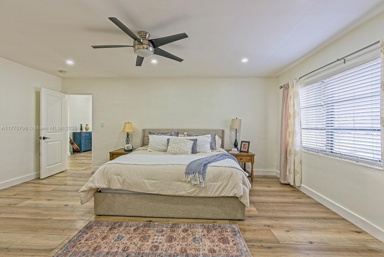 10900 Southwest 124th Road Miami, FL 33176 - Photo 14 of 22 a bedroom with a large bed and a ceiling fan