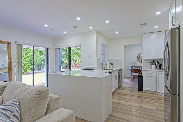 a living room with furniture and large windows