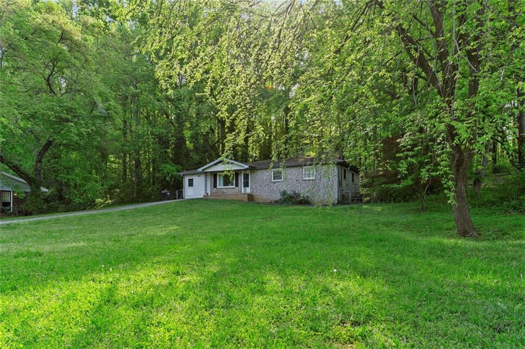 2070 Mulkey Road Southwest Marietta, GA 30008 - Photo 1 of 1 a view of a backyard with large trees