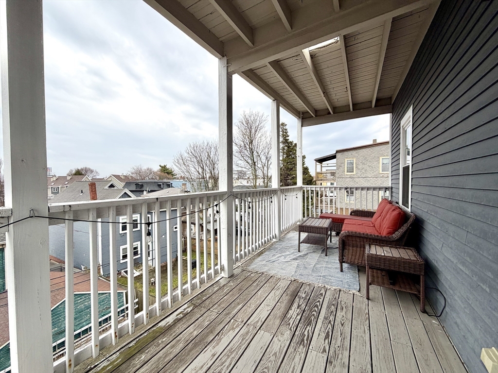37 Moseley Street, Unit 3 Boston, MA 02125 - Photo 15 of 17 a view of a balcony with chair and wooden floor