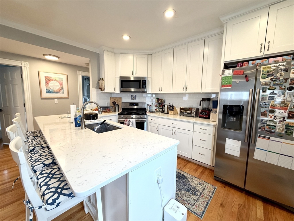 37 Moseley Street, Unit 3 Boston, MA 02125 - Photo 3 of 17 a kitchen with a refrigerator a stove a sink dishwasher a refrigerator and cabinets with wooden floor