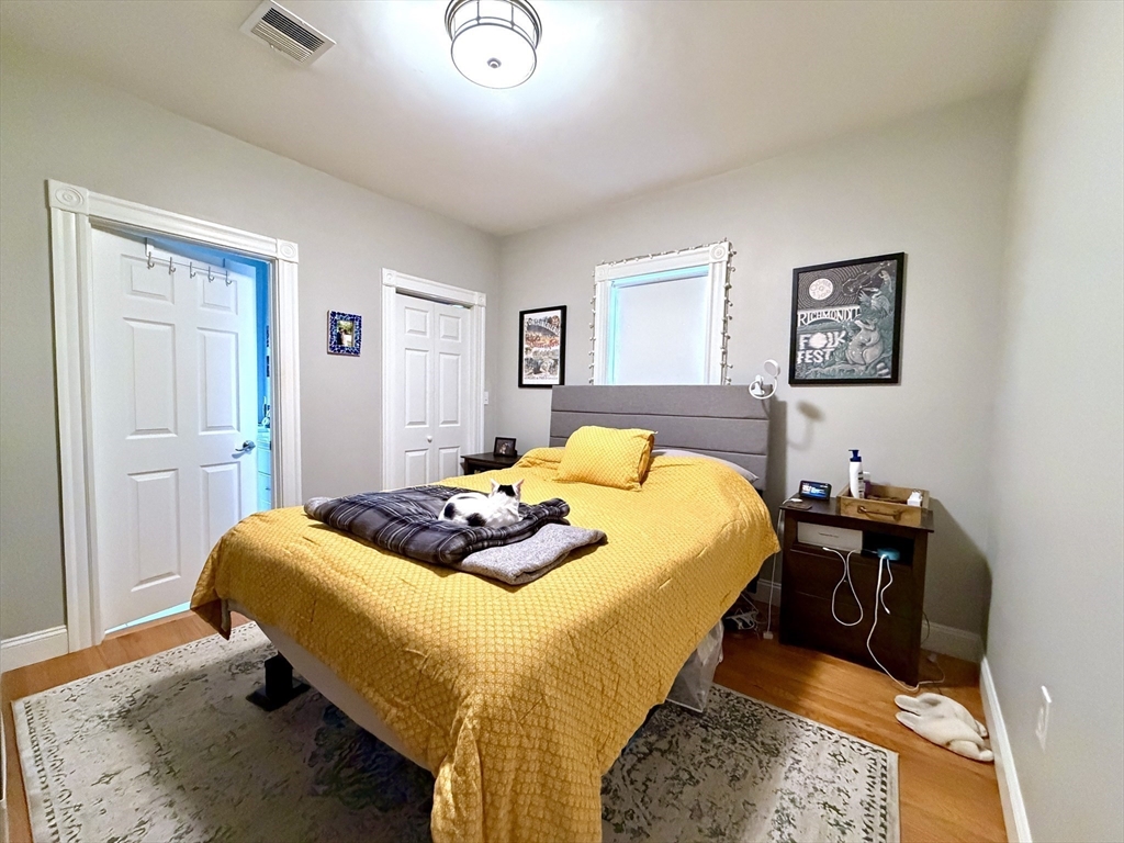 37 Moseley Street, Unit 3 Boston, MA 02125 - Photo 9 of 17 a bedroom with a bed and wooden floor