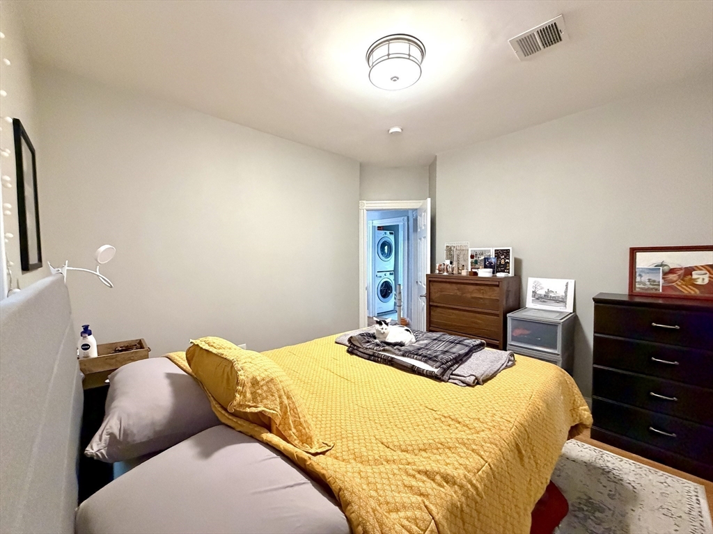 37 Moseley Street, Unit 3 Boston, MA 02125 - Photo 10 of 17 a bedroom with a bed and a chandelier