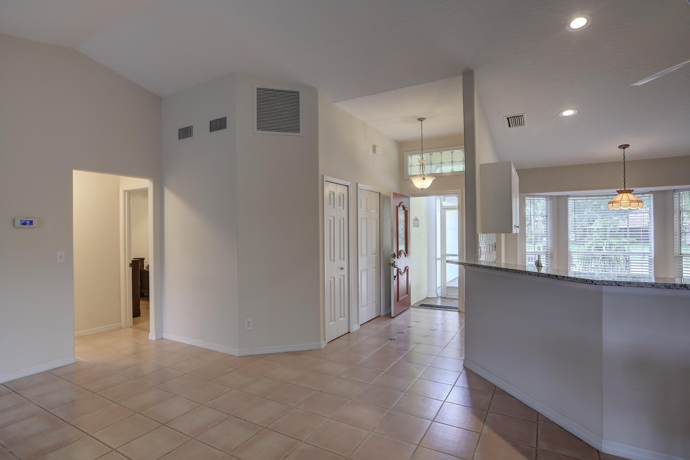 1245 George Street Sebastian, FL 32958 - Photo 14 of 36 a view of a hallway with stainless steel appliances granite countertop cabinets and chandelier