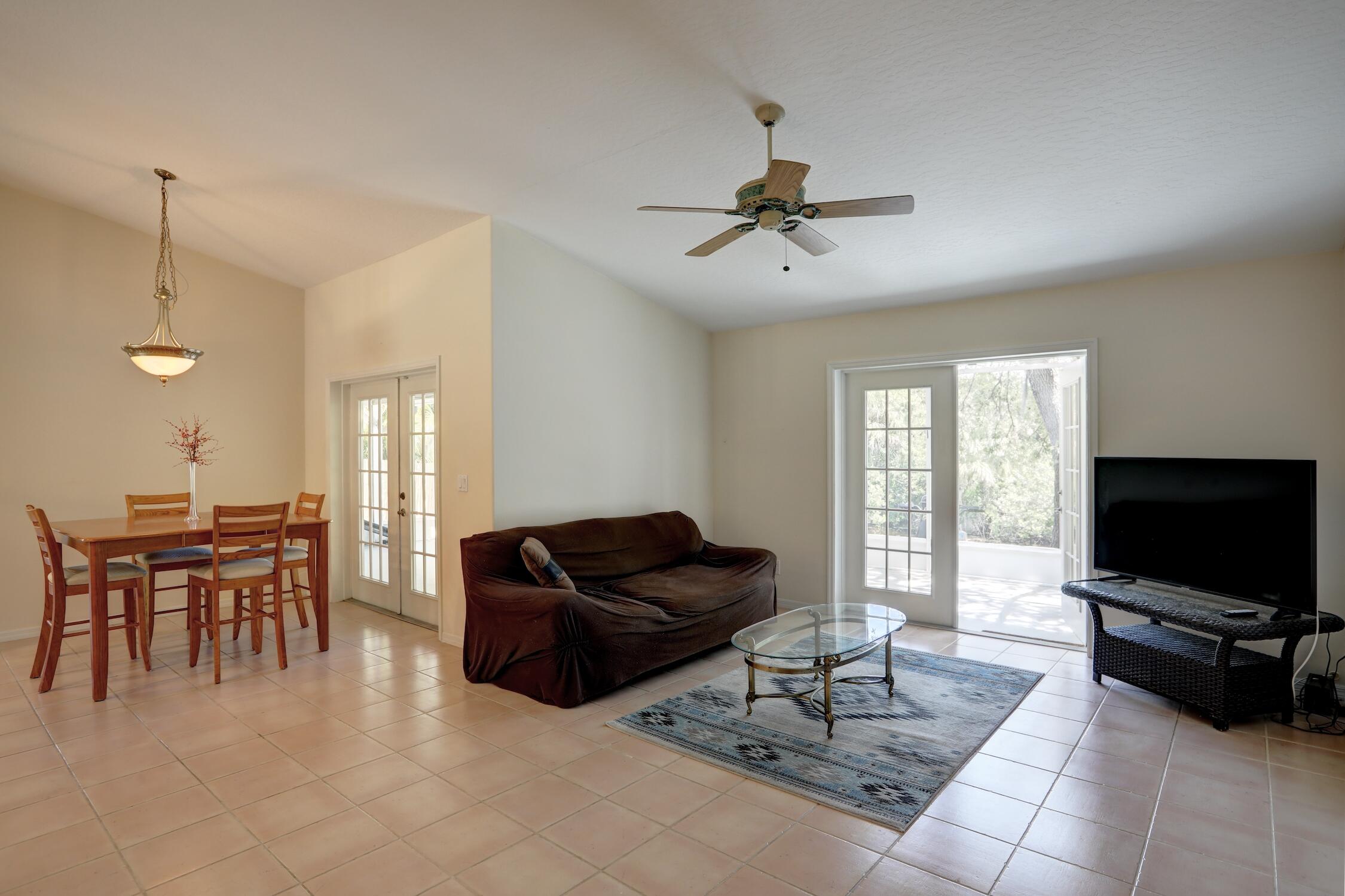 1245 George Street Sebastian, FL 32958 - Photo 16 of 36 a living room with furniture a flat screen tv and a window
