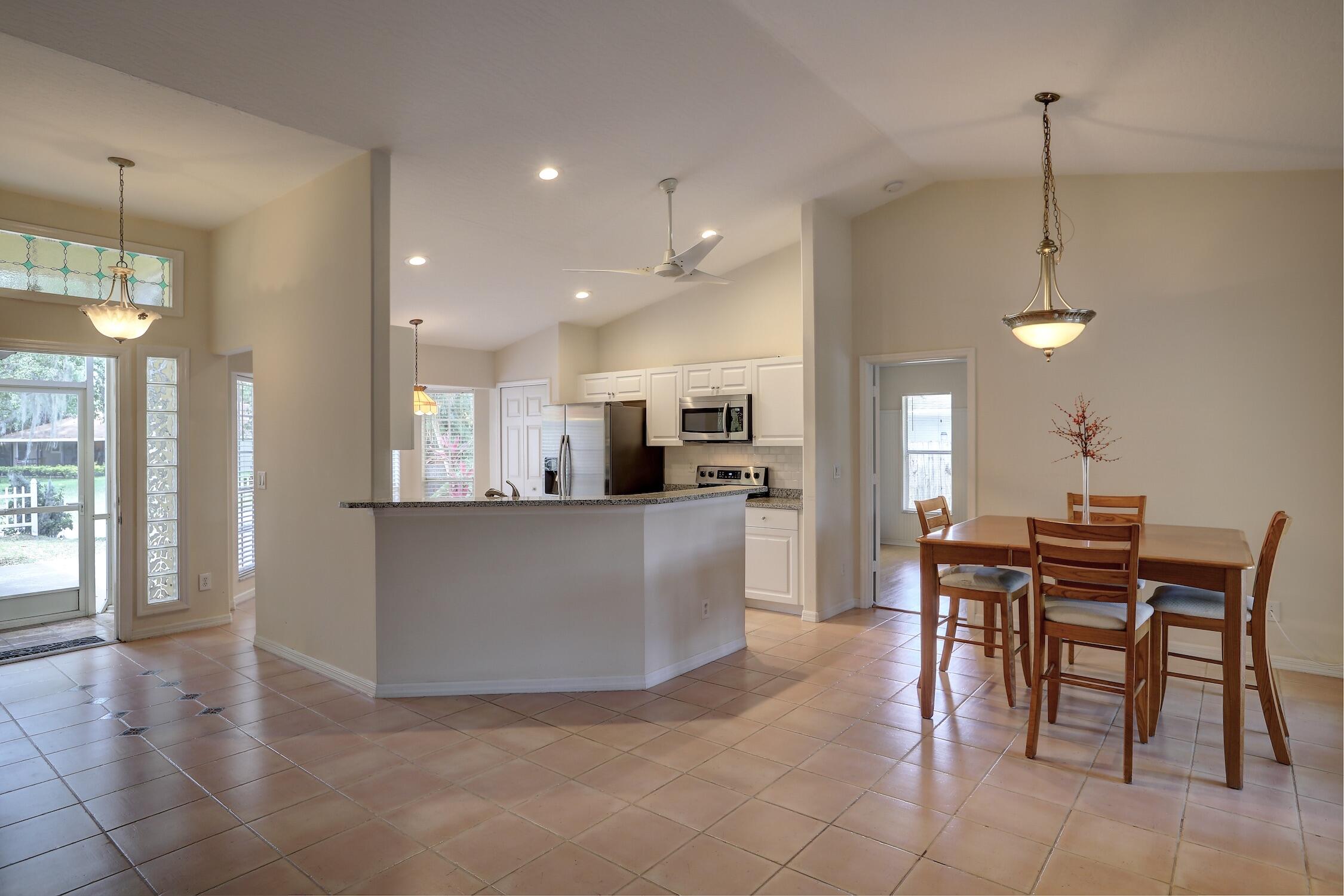 1245 George Street Sebastian, FL 32958 - Photo 19 of 36 a view of a dining room and livingroom with furniture wooden floor a chandelier