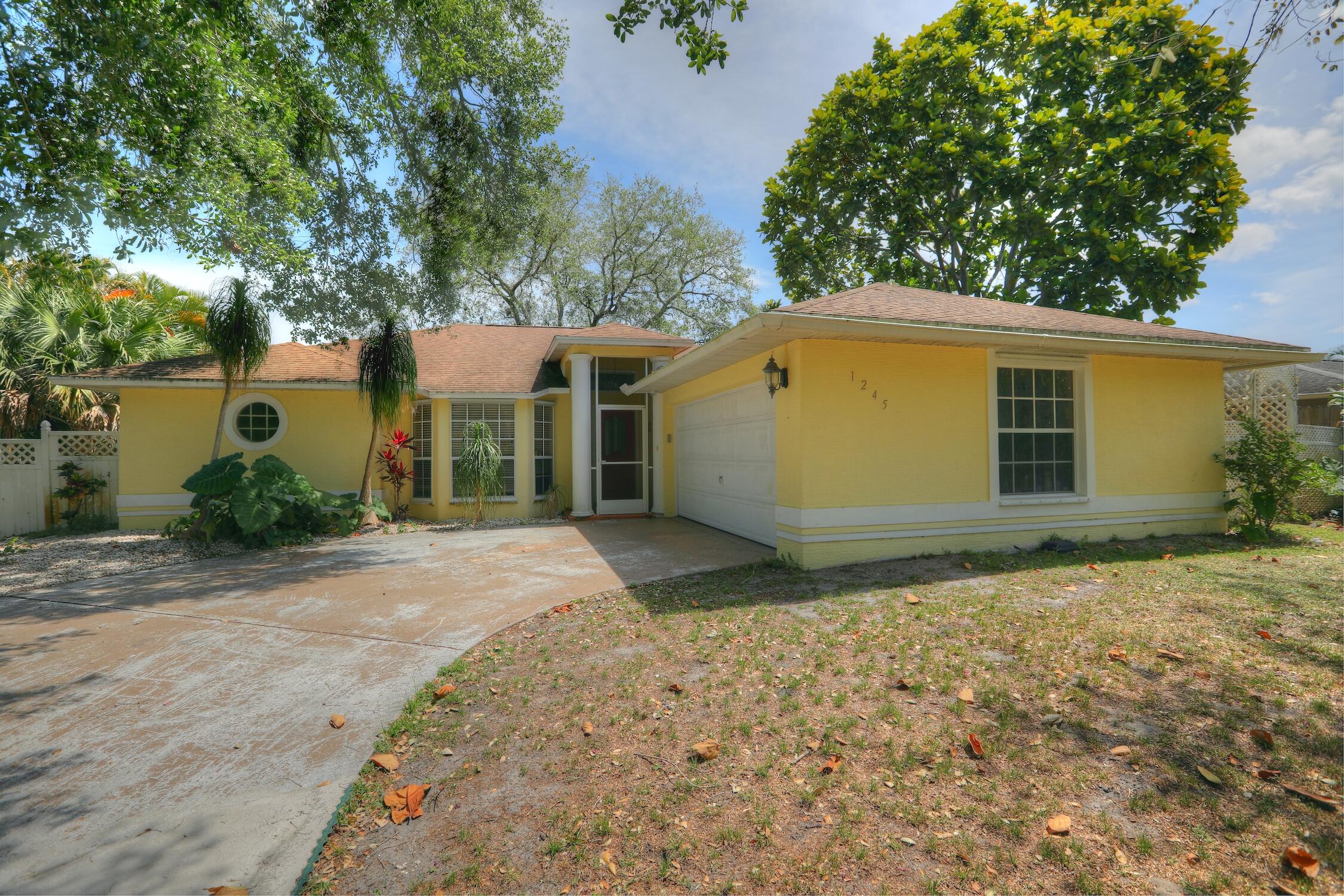 1245 George Street Sebastian, FL 32958 - Photo 2 of 36 a house with trees in front of it