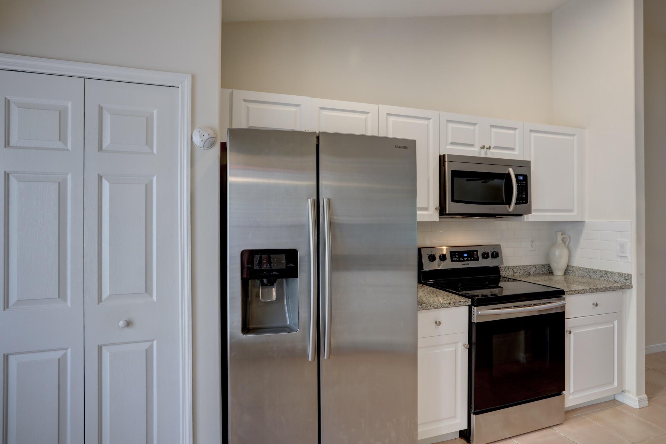 1245 George Street Sebastian, FL 32958 - Photo 26 of 36 a kitchen with a refrigerator stove and microwave
