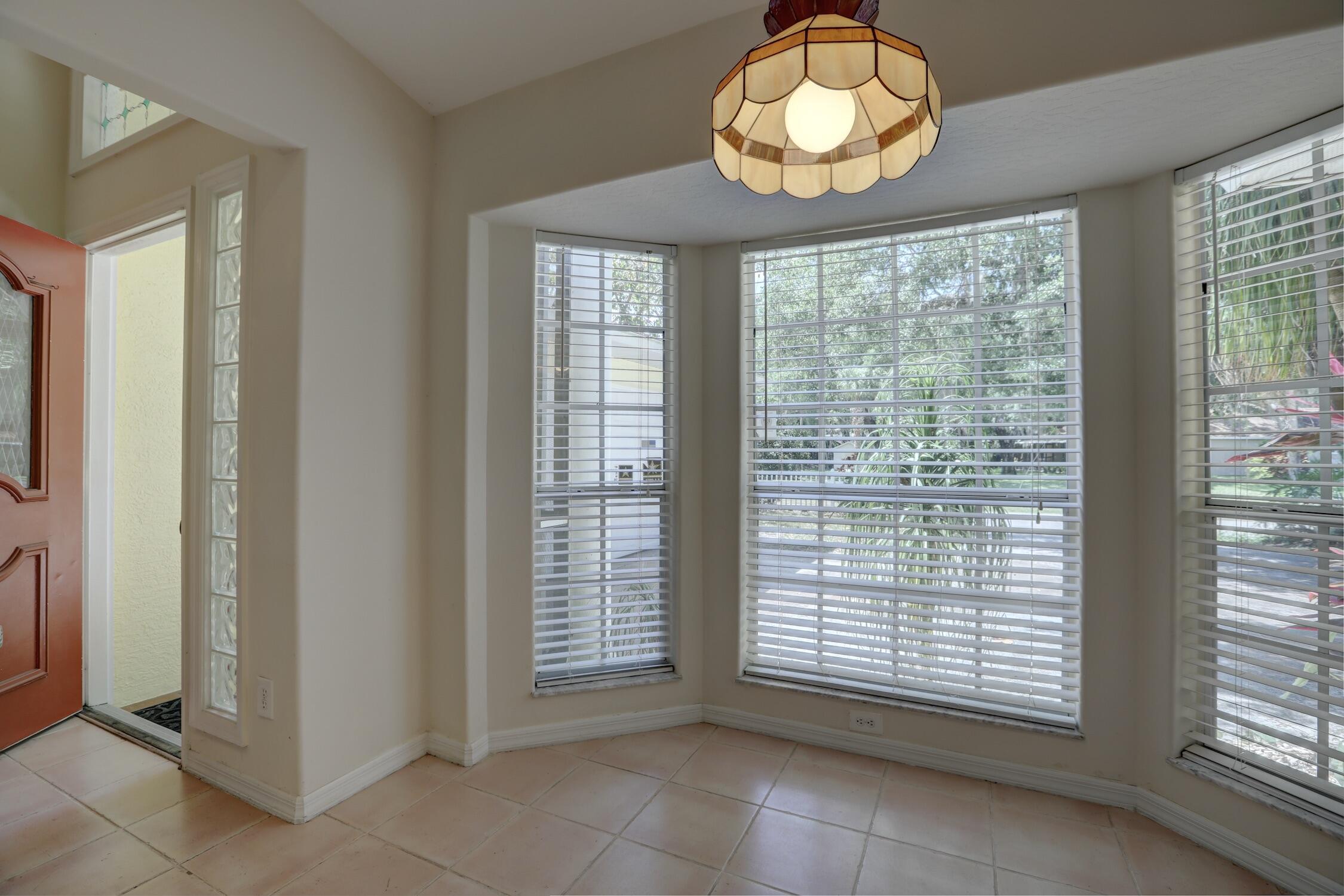 1245 George Street Sebastian, FL 32958 - Photo 27 of 36 a view of an empty room with a window and a chandelier