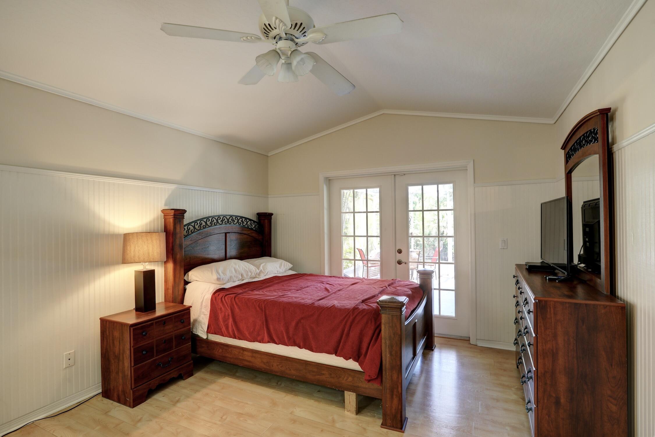 1245 George Street Sebastian, FL 32958 - Photo 28 of 36 a bedroom with a bed and wooden floor