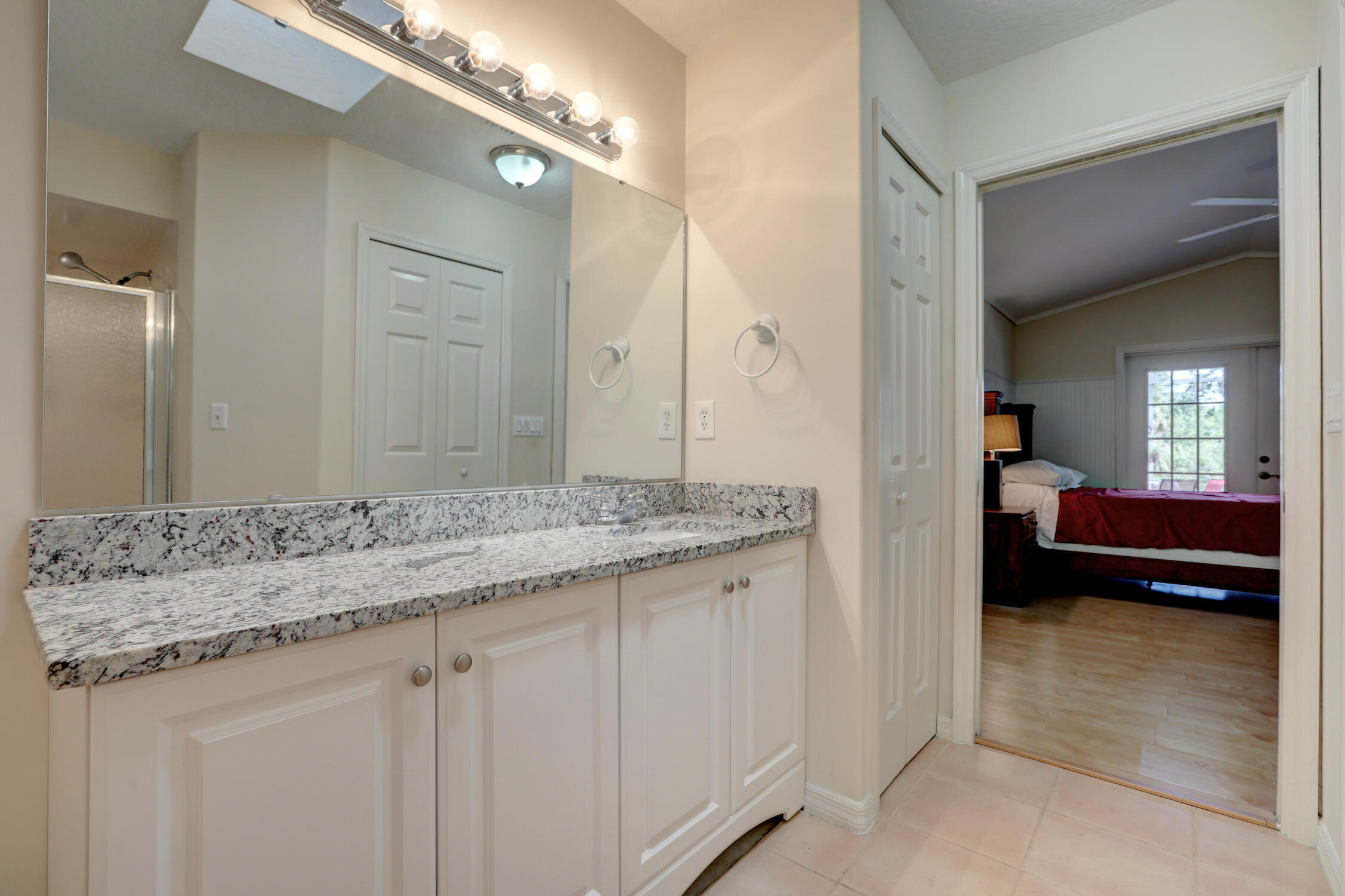 1245 George Street Sebastian, FL 32958 - Photo 29 of 36 a en suite bathroom with a granite countertop sink and a mirror