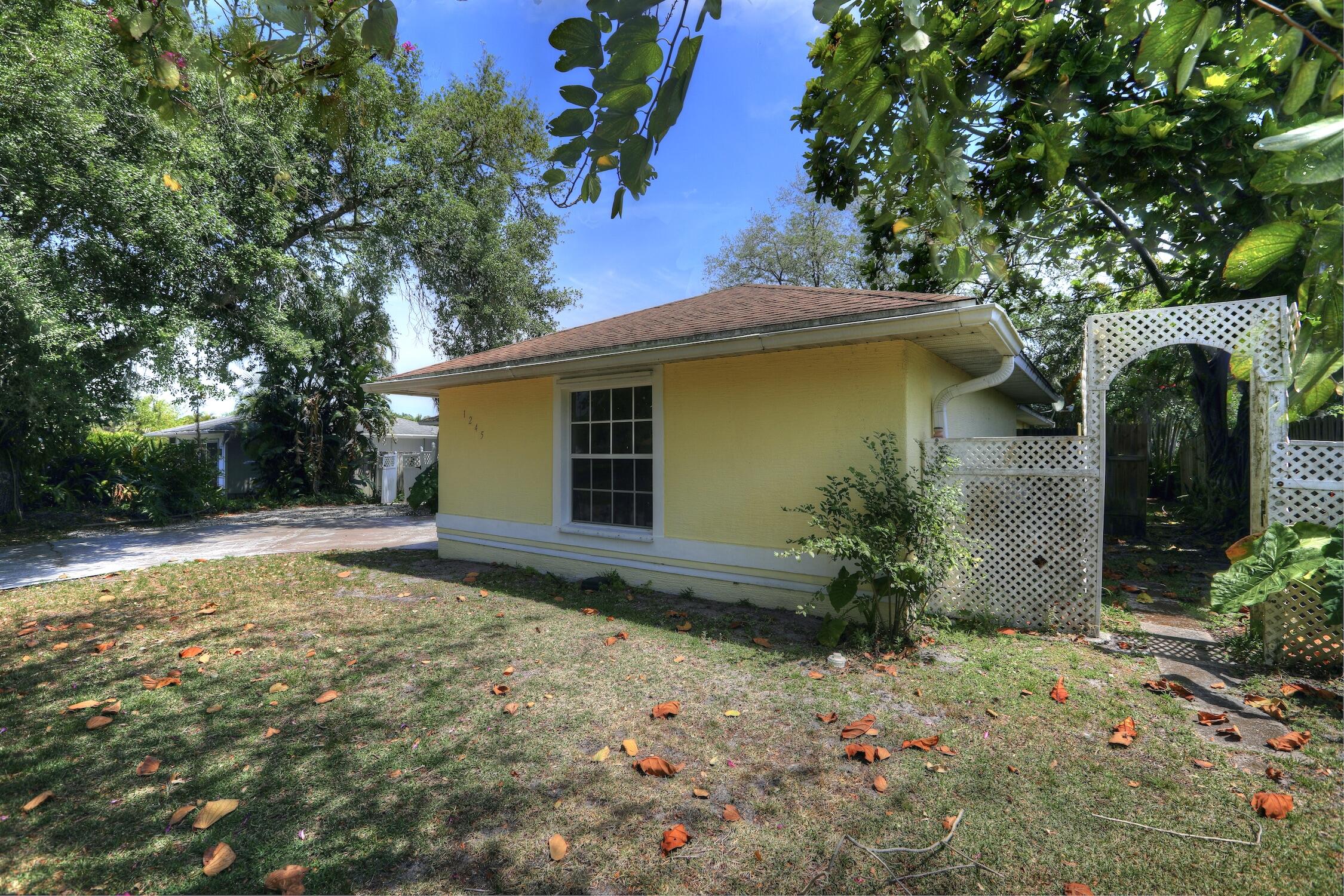 1245 George Street Sebastian, FL 32958 - Photo 3 of 36 a view of a backyard with plants and large tree
