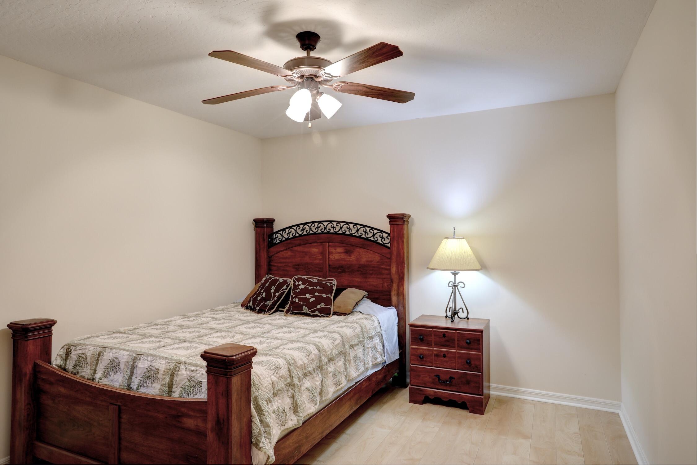 1245 George Street Sebastian, FL 32958 - Photo 32 of 36 a bedroom with a bed and a chandelier