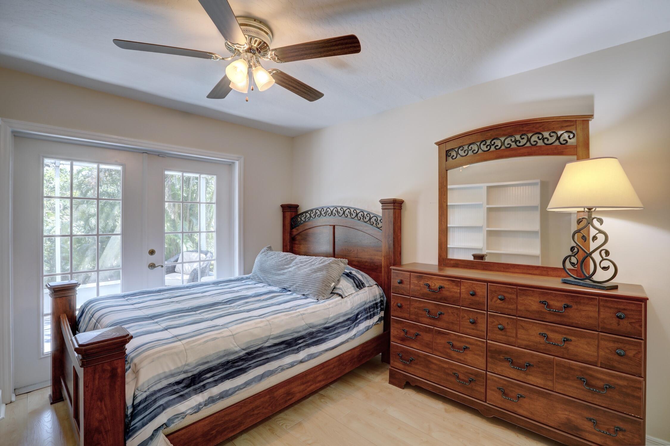 1245 George Street Sebastian, FL 32958 - Photo 33 of 36 a bedroom with a bed and a chandelier