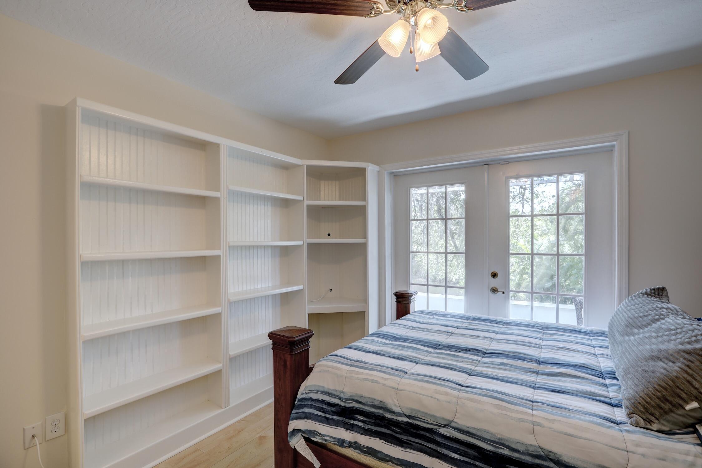 1245 George Street Sebastian, FL 32958 - Photo 34 of 36 a bedroom with a bed and a chandelier