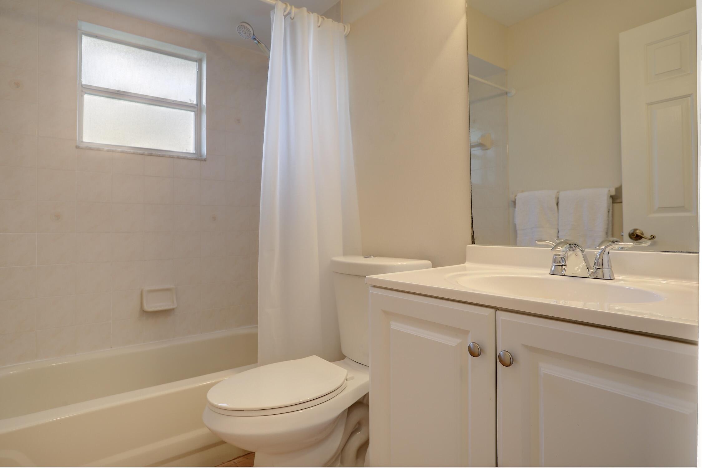 1245 George Street Sebastian, FL 32958 - Photo 35 of 36 a bathroom with a granite countertop sink toilet and shower