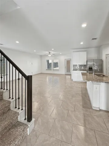 a view of a kitchen with kitchen island granite countertop lots of counter top space