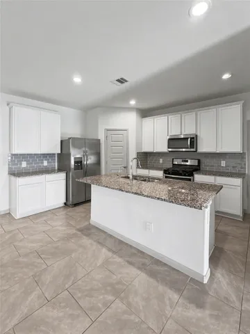 a large kitchen with cabinets