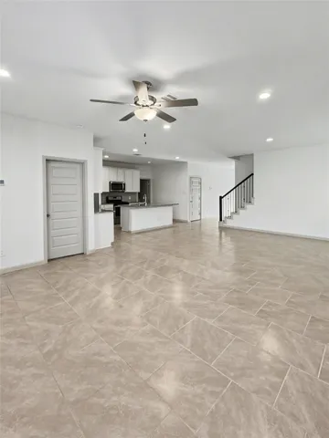a view of a kitchen with an empty space and a ceiling fan