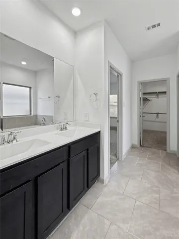 a bathroom with a sink double vanity and a mirror