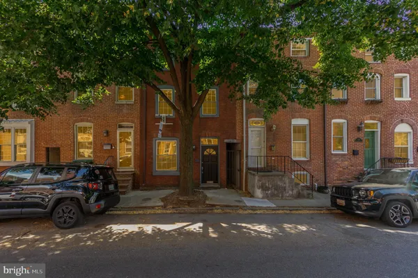 a view of a car park in front of a brick house
