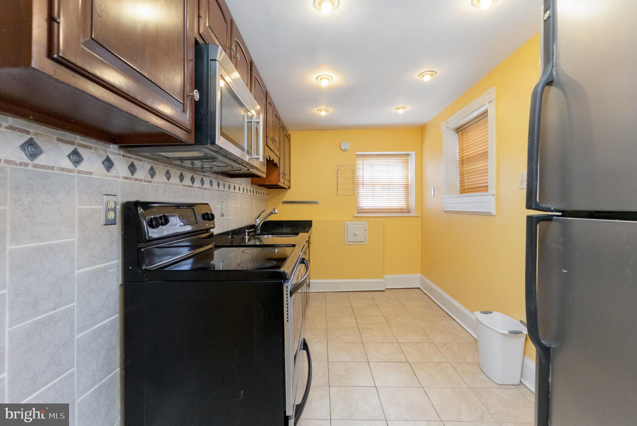 1118 Riverside Avenue Baltimore, MD 21230 - Photo 11 of 28 a kitchen with stainless steel appliances granite countertop a refrigerator a sink and a stove