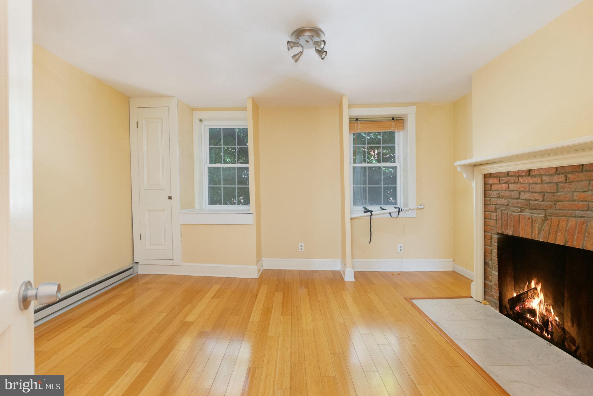 1118 Riverside Avenue Baltimore, MD 21230 - Photo 12 of 28 a view of a livingroom with wooden floor and a fireplace