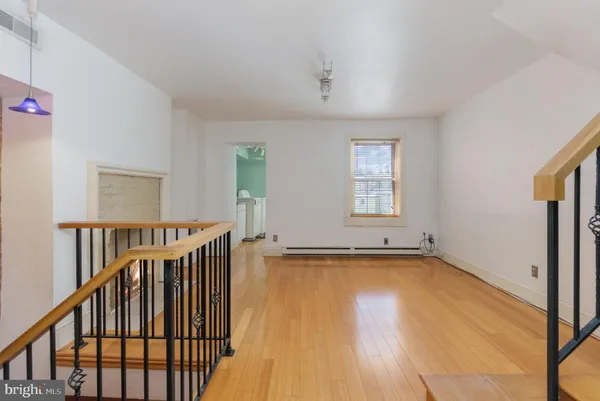 a view of a room with wooden floor and windows