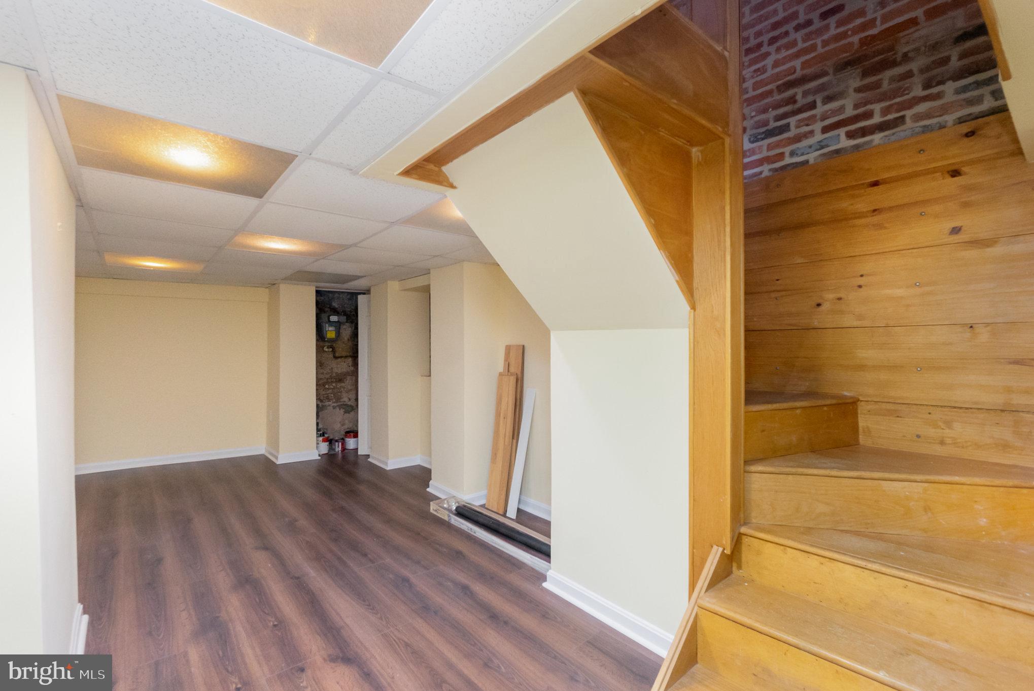1118 Riverside Avenue Baltimore, MD 21230 - Photo 16 of 28 a view of an empty room with wooden floor and a window