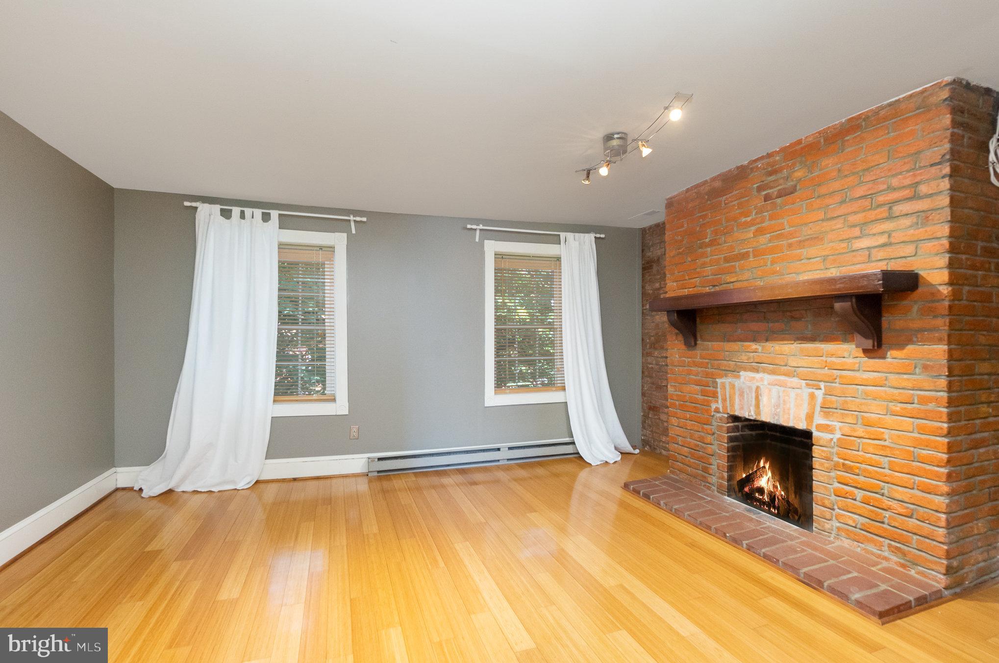 1118 Riverside Avenue Baltimore, MD 21230 - Photo 18 of 28 a view of an empty room with a fireplace and a window